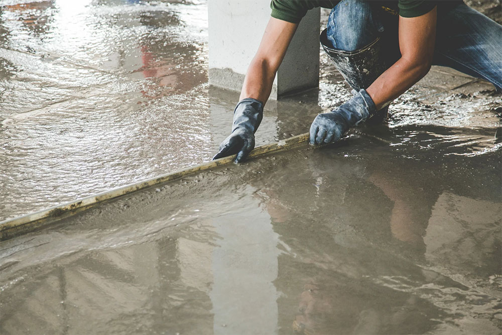 vecteezy_mason-building-a-screed-coat-cement_19884863-scaled